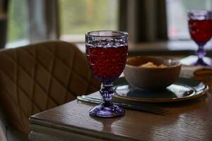 table setting glasses with compote, plates salad photo