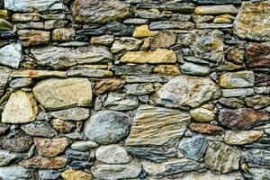 a stone wall with many different types of rocks photo