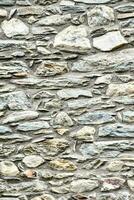 a stone wall with many different types of rocks photo