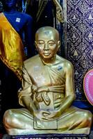 a gold buddha statue in a shop with other items photo