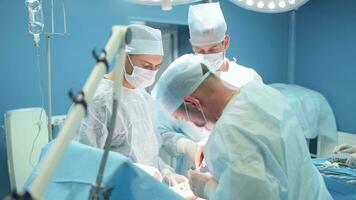 A team of surgeons performed a successful operation, stitches and stitches up the wound. video