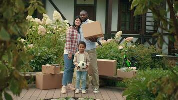 Portrait of a multi-ethnic family during a move to a new home. African dad, Caucasian mom, son. video