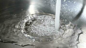 slow motion of water pouring from a faucet tap slow motion video