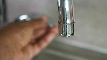 water pouring from a faucet tap slow motion video