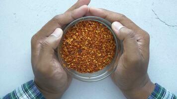 top view of holding a bowl of chili flakes video