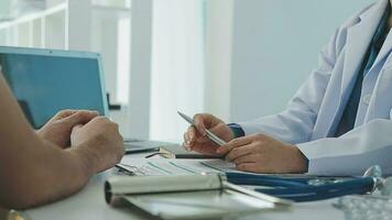 Doctor and patient sitting and talking at medical examination  video