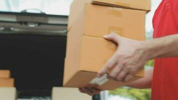 Delivery man giving cardboard boxes to a man video