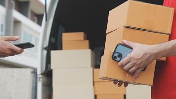 Fast and reliable service. Cheerful young delivery man giving a cardboard box to young woman while standing at the entrance of her apartment video