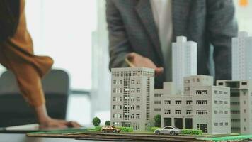 Business meetings of real estate brokers and company presidents to select a model to build a housing estate in writing and presenting to state organizations. video