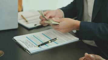 Business and lawyers discussing contract papers with brass scale on desk in office. Law, legal services, advice, justice and law concept picture with film grain effect video