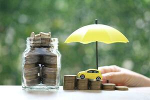 Miniature car model on growing stack of coins money on nature green background, Saving money for car, Finance and car loan, Investment and business concept photo