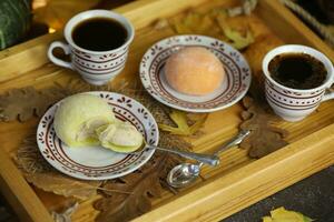 Colorful japanese sweets daifuku or mochi sliced. Sweets close up on the plate with cup of coffee photo