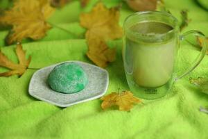 vistoso japonés dulces daifuku o mochi rebanado. dulces cerca arriba en el plato con taza de matcha té foto