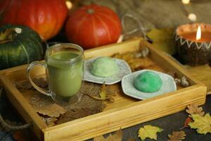 Colorful japanese sweets daifuku or mochi sliced. Sweets close up on the plate with cup of matcha tea photo