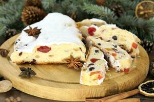 Sliced Chrismas stollen with powdered sugar and christmas decoration photo