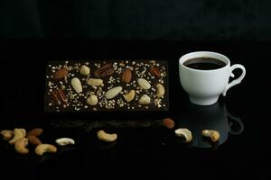 Homemade chocolate with cup of coffee and nuts photo