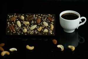 Homemade chocolate with cup of coffee and nuts photo