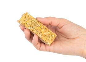 Woman's hand holding energy protein bar isolated on white background. Close-up. photo