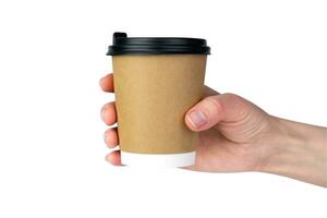 Woman's hand holds a craft disposable paper cup with fresh coffee isolated on a white background. Close-up. photo