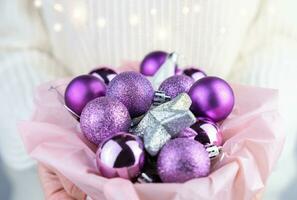 Women's hands hold a Christmas decorations. Close-up. Selective focus. photo