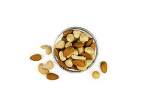 Mix of nuts in a glass bowl isolated on white background. Top view. Healthy food. Banner. Close-up. photo