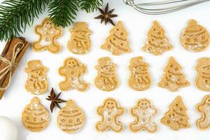 Baking Christmas cookies in the shape of a Christmas tree, snowman, Christmas ball and a gingerbread man. Top view. photo