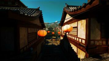 A narrow alley with lanterns hanging from the ceiling photo