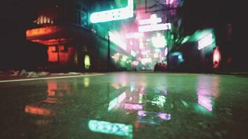 A city street at night with neon lights photo