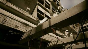 A building with a complex network of wires attached to its concrete roof photo