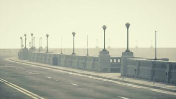 Old empty bridge on a foggy day photo