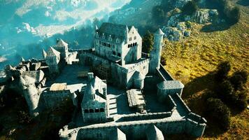 Old ruined castle in the misty mountains photo