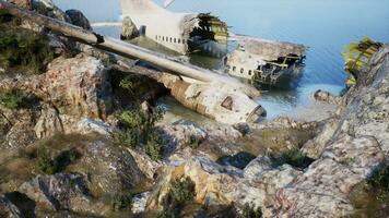 Plane wreck on the beach with rocks near ocean photo