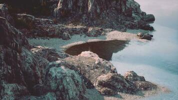 beach and limestone cliffs against azure water photo