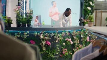 Store manager checking past customers transactions in thrift shop at checkout counter. Meticulous employee doing cash register end of day report in empty second hand store video