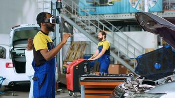 Mechanic in repair shop using advanced virtual reality technology to visualize car mechanical component in order to fix it. BIPOC garage employee wearing vr goggles while mending broken vehicle photo