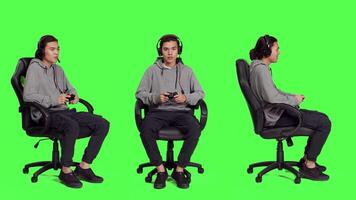 Guy having fun with competition over full body greenscreen background, playing online videogames with joystick. Young person enjoying online gaming tournament, game player with skill. video