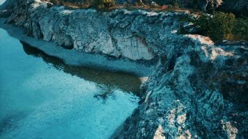 beach and limestone cliffs against azure water photo