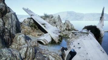 Decrepit airplane on jagged island shoreline photo