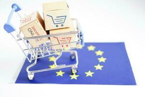 Online shopping, Shopping cart box on EU European Union flag, import export, finance commerce. photo