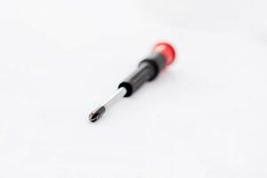 Red and black handled screwdriver on a white background photo