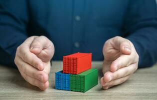 Man protects shipping containers with his hands. Security, reliability, and protection of the global supply chain. Safe transit of goods against potential threats and risks. Prevent compromise photo