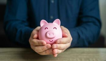A man protects his savings. The piggy bank is in good hands. Savings and deposit banking. Wealth and prosperity. Healthy economy. Successful investments and deposits. Money protection. photo