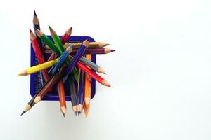 Top view of crayon or colored pencils in box on white background. Knowledge and education concept. photo