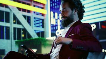 Banking expert reads digital investment news on phone while sitting on bench, admiring street lights downtown. Company shareholder in a suit trying to solve financial problems for CEO. video