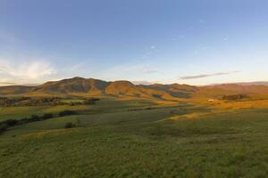 First sunshine of the day on the mountain photo