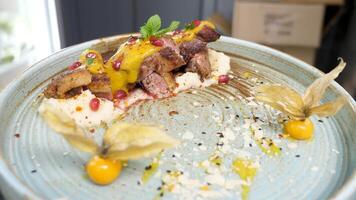 Firts person view of plate with grilled duck breast and mashed potatoes on a plate. The waiter is picking them up and goes in the restaurant to serve them to the client. video