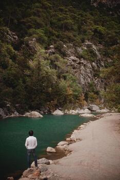 Man on the background of a mountain lake, tranquility and unity with nature in Turkey trees photo