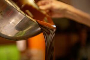 Chocolatier Pouring Chocolate photo