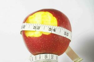 an apple with a measuring tape around it photo