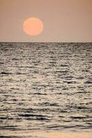 Sunset over the ocean photo